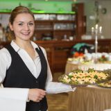 Catering service employee or waitress with a tray of appetizers